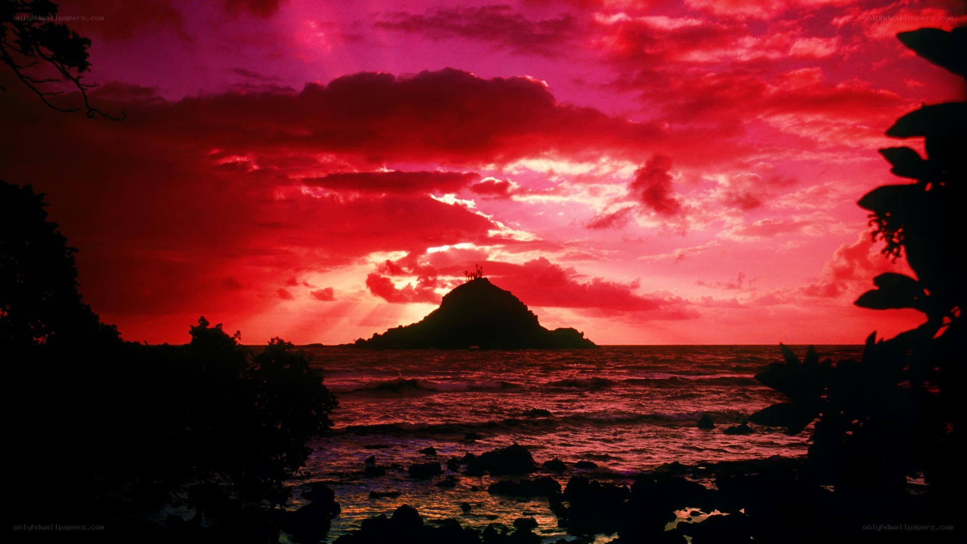 Red sunset over volcanic island