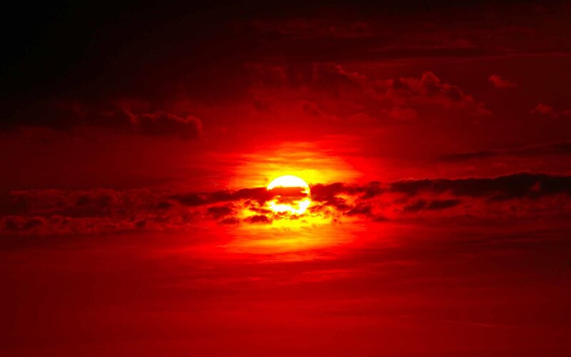 Red sunset with sun partially hidden