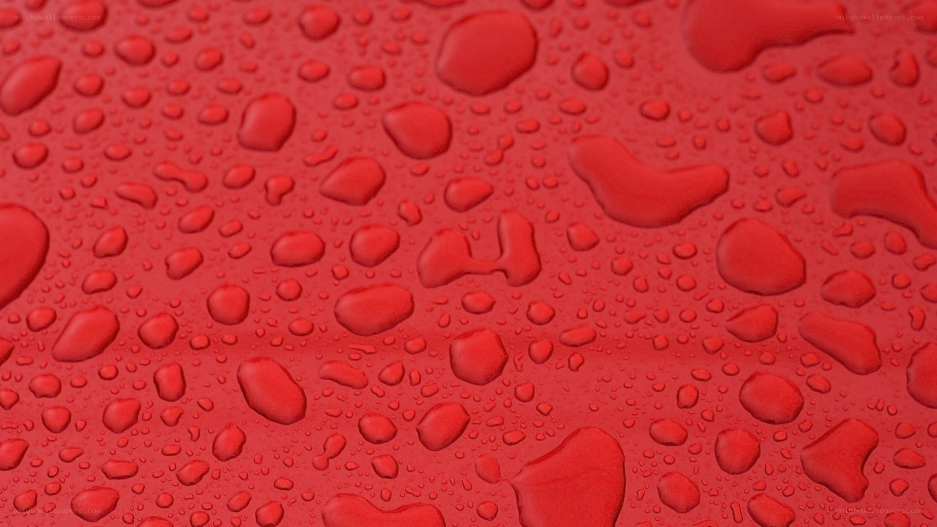 red surface with water droplets
