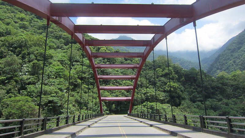 Red Suspension Bridge — Green, Serene, Afternoon