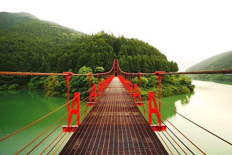 Red suspension bridge over river