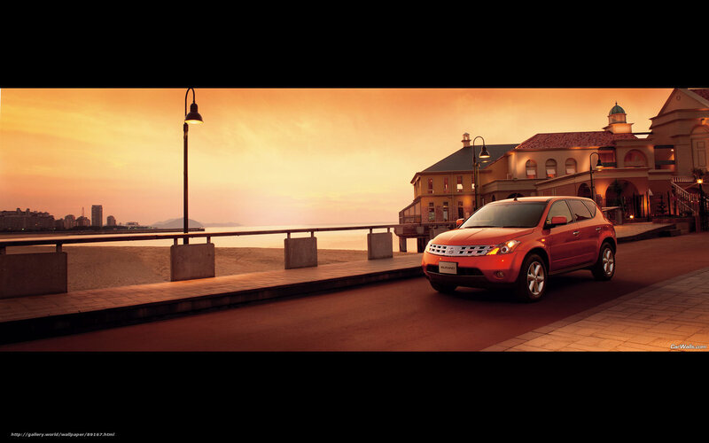 Red SUV at sunset by the sea