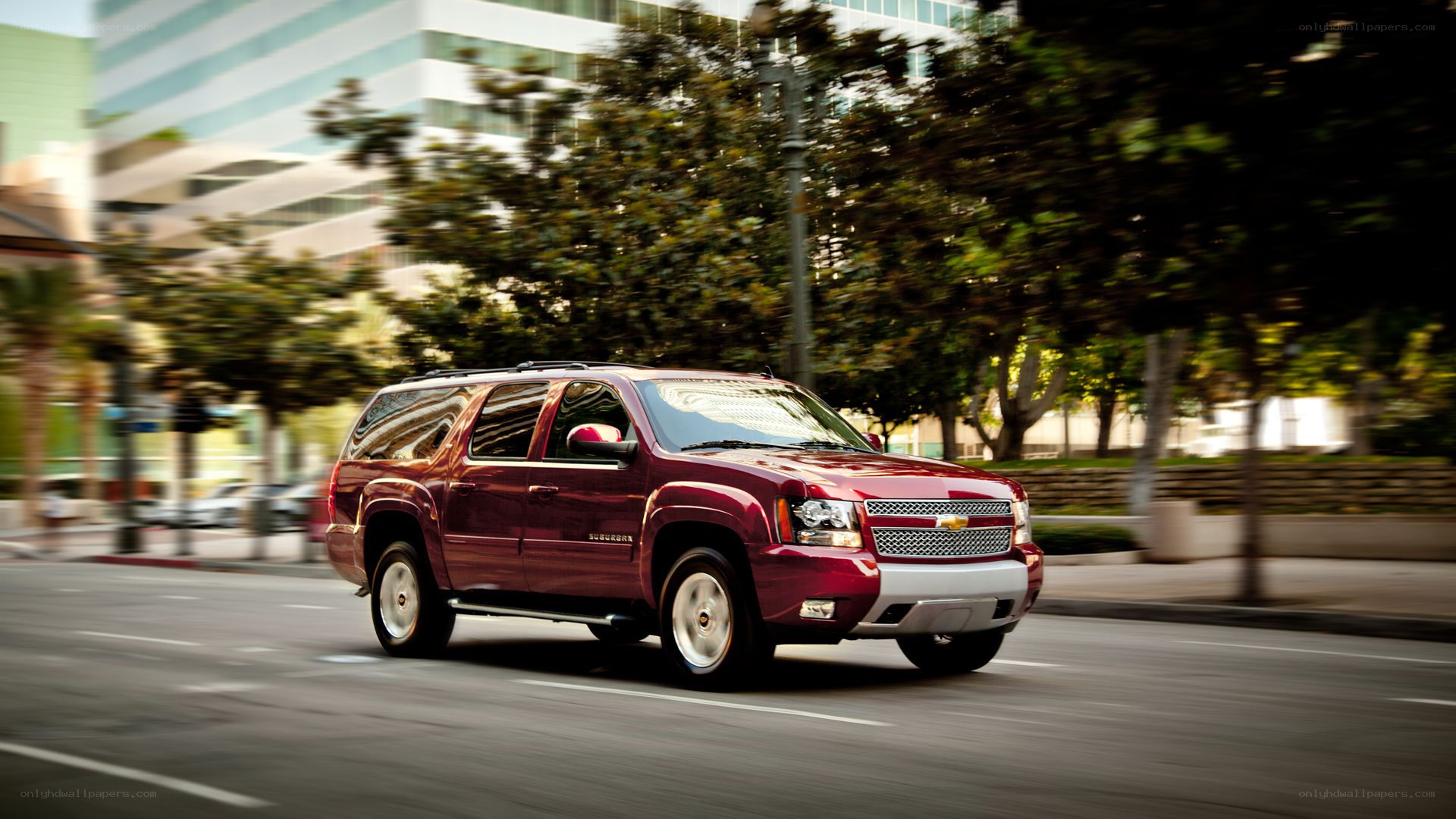 Red SUV driving on city street