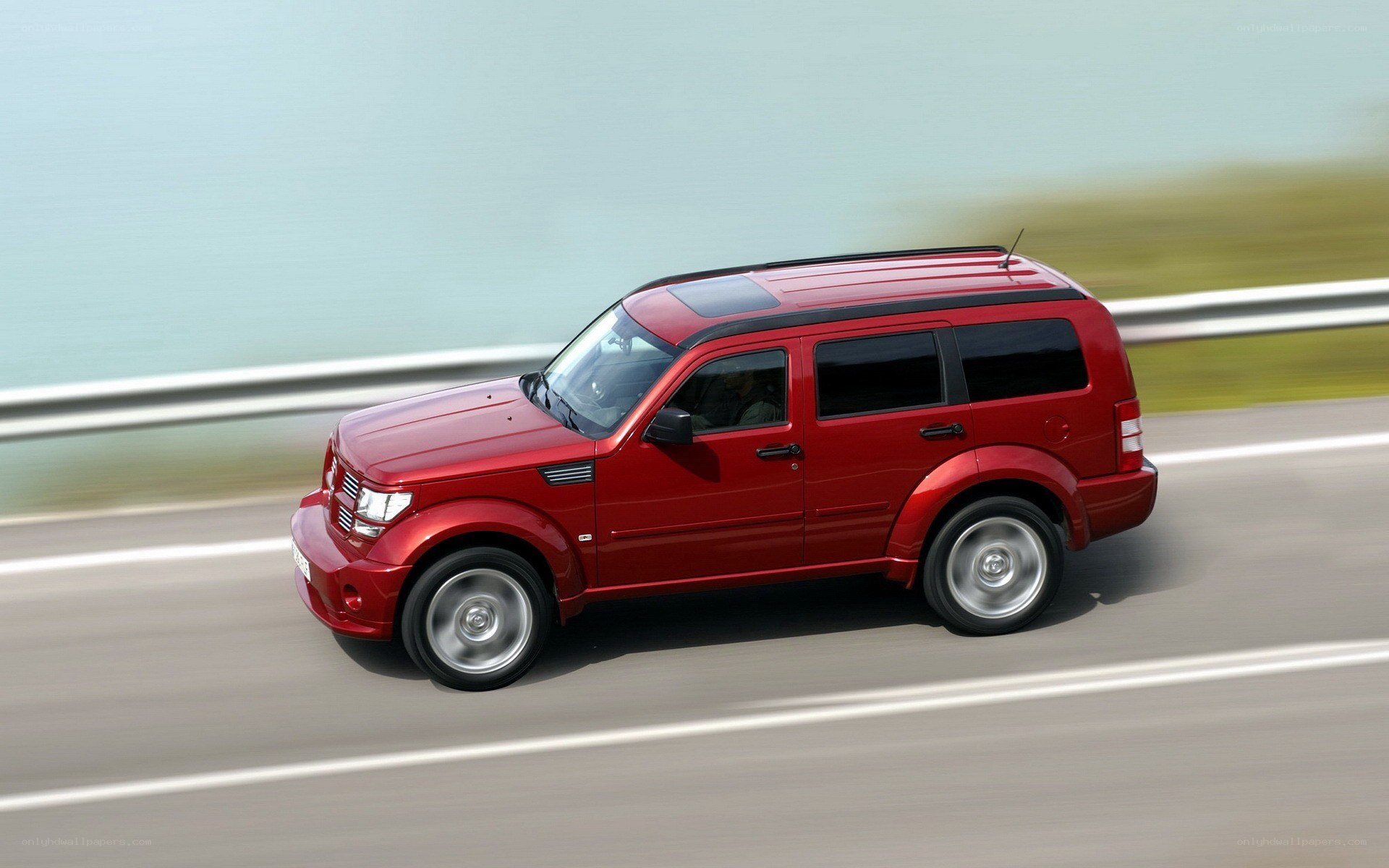 Red SUV driving on highway