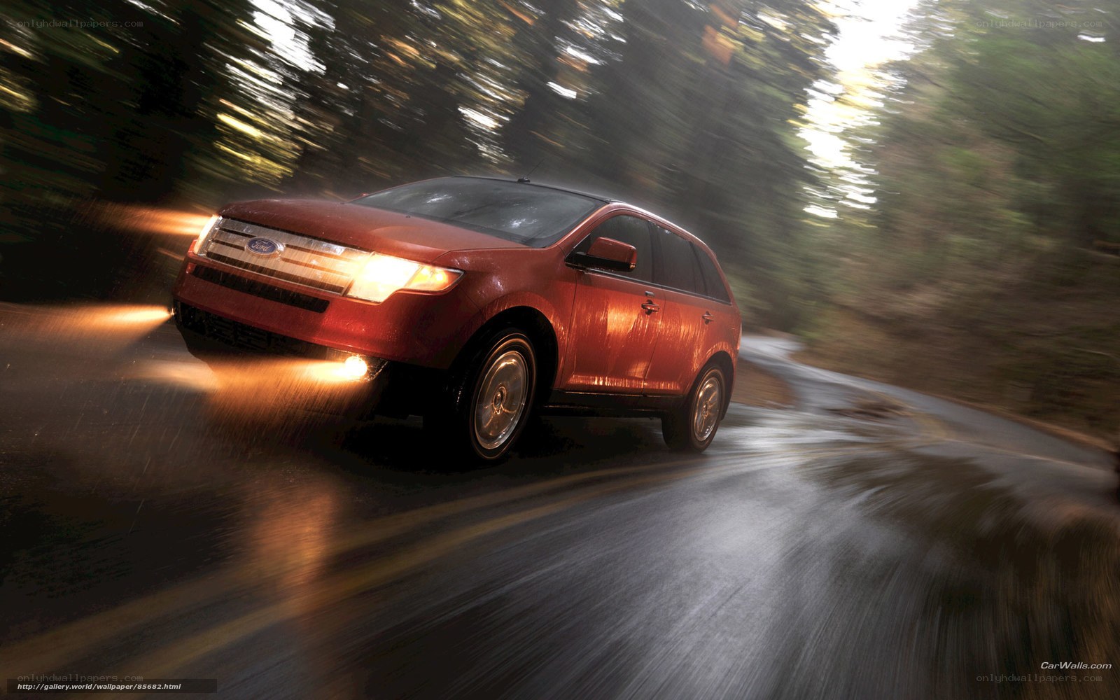 Red SUV driving on wet road