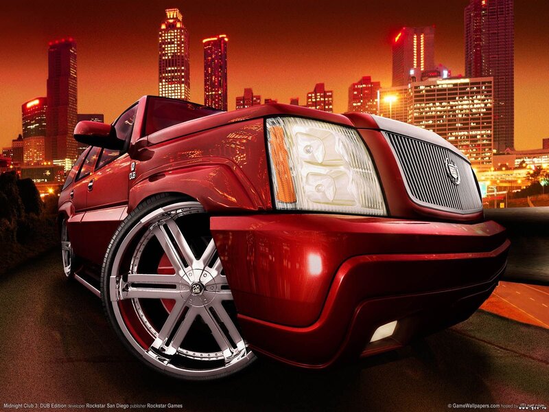 Red SUV in city at night