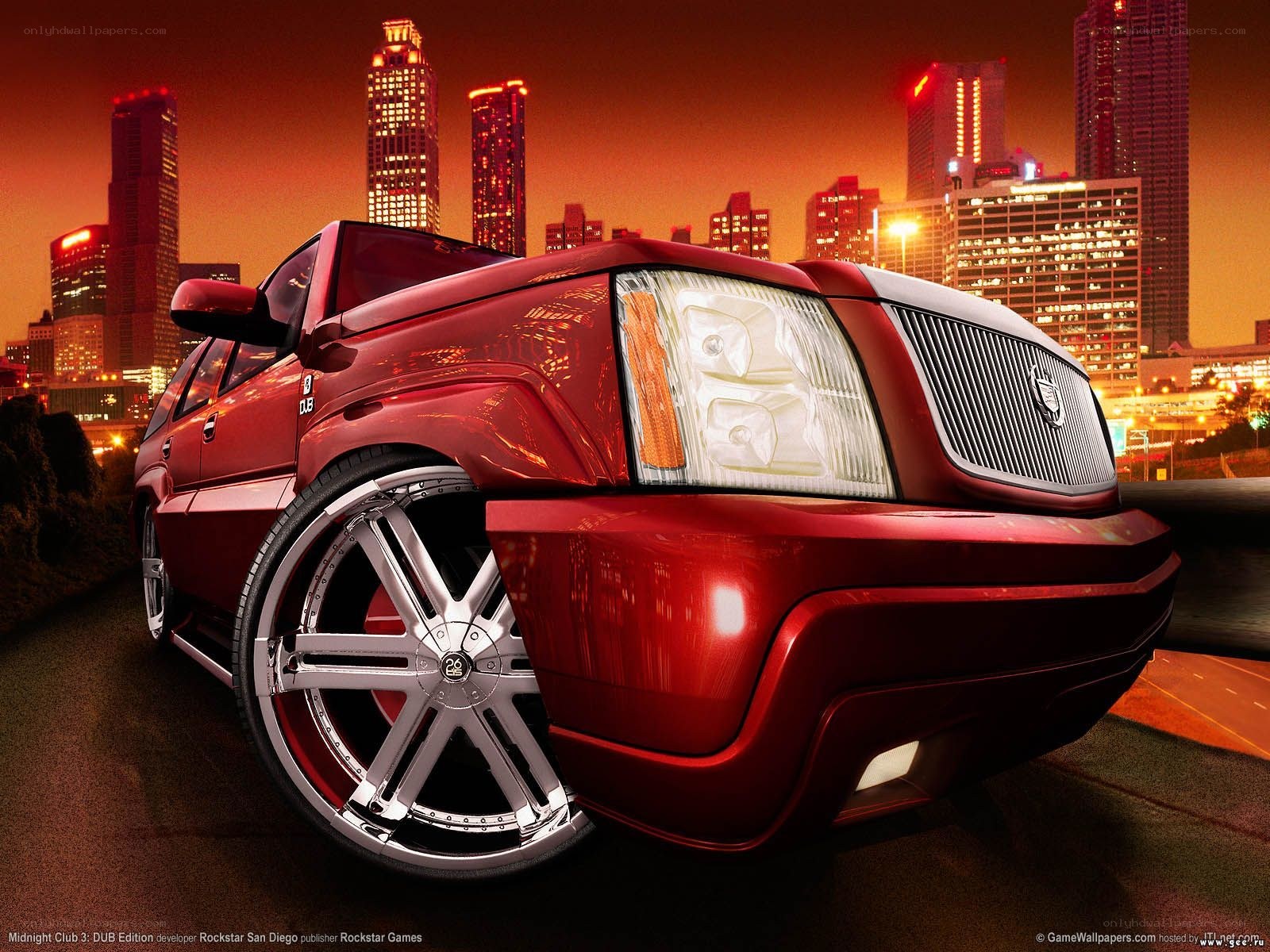 Red SUV in city at night