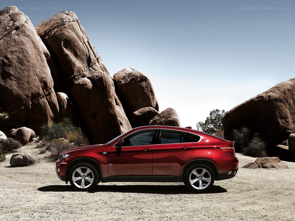 Red SUV in desert landscape
