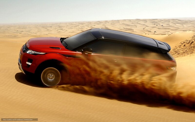 Red SUV in desert sand
