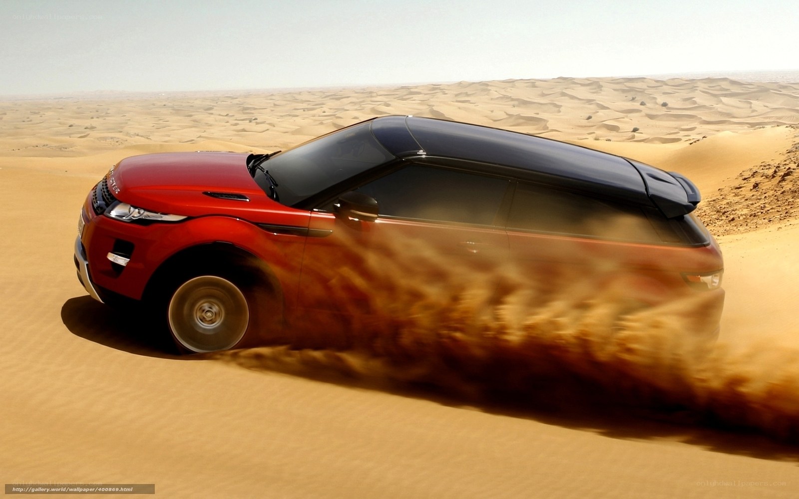 Red SUV in desert sand