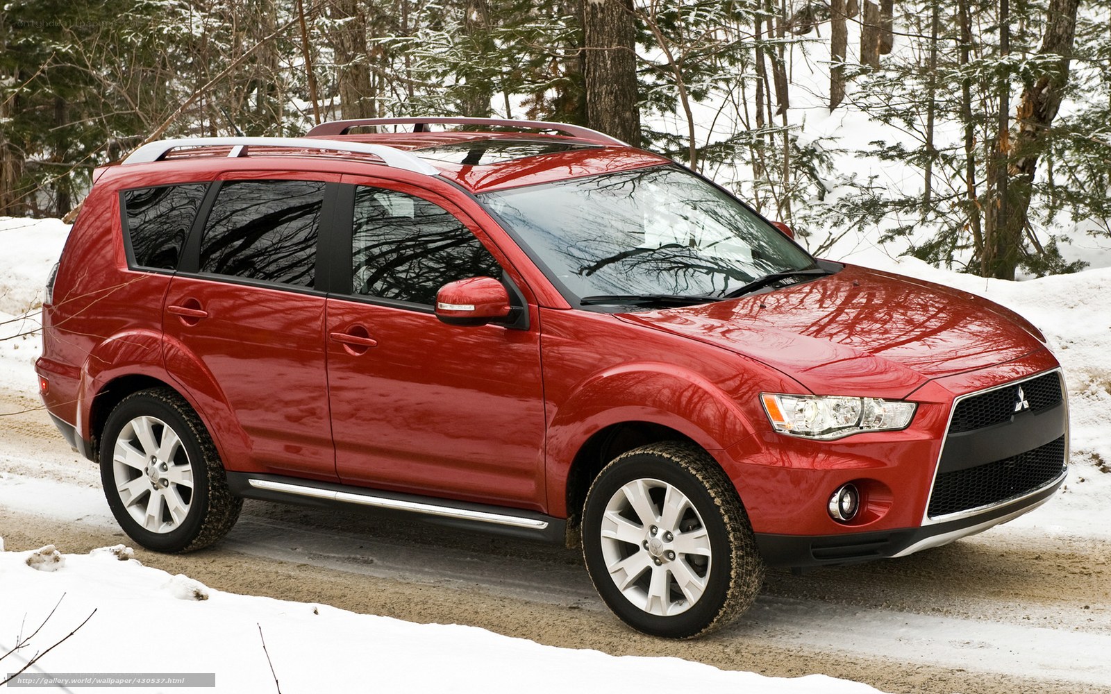 Red SUV in snowy forest