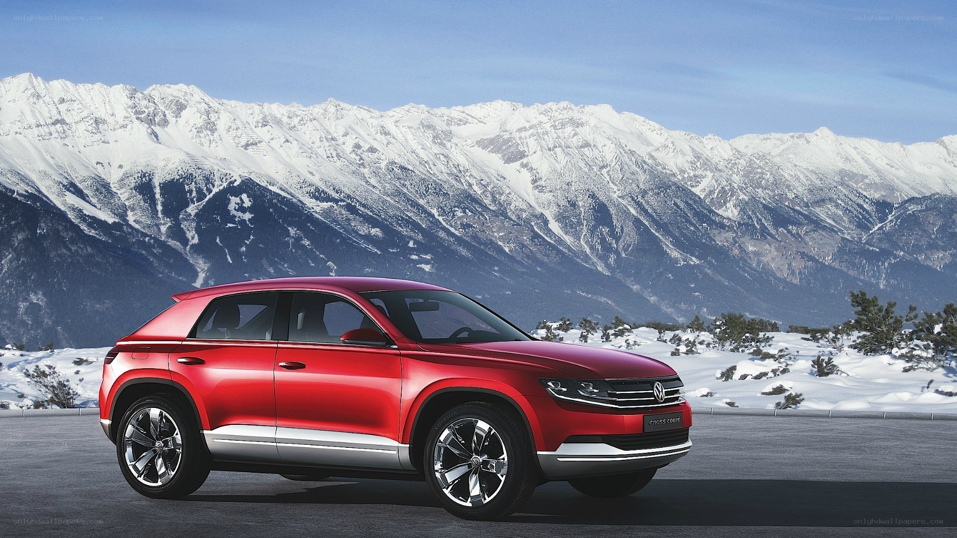 Red SUV in snowy mountains