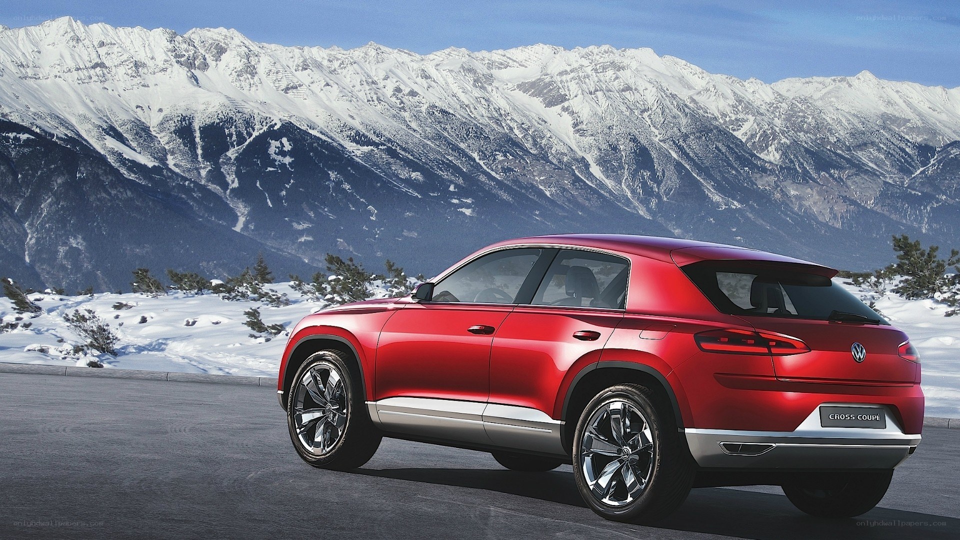 Red SUV in snowy mountains
