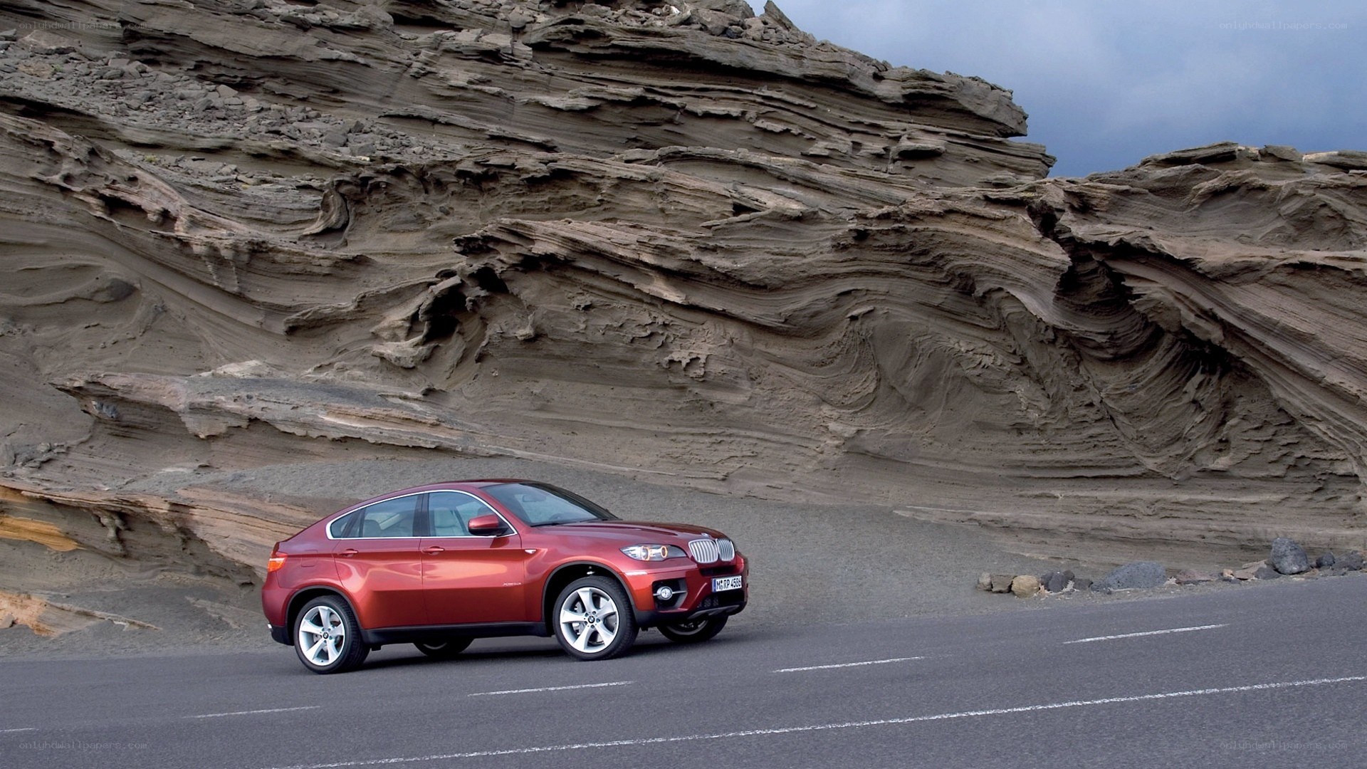 Red SUV on a coastal road