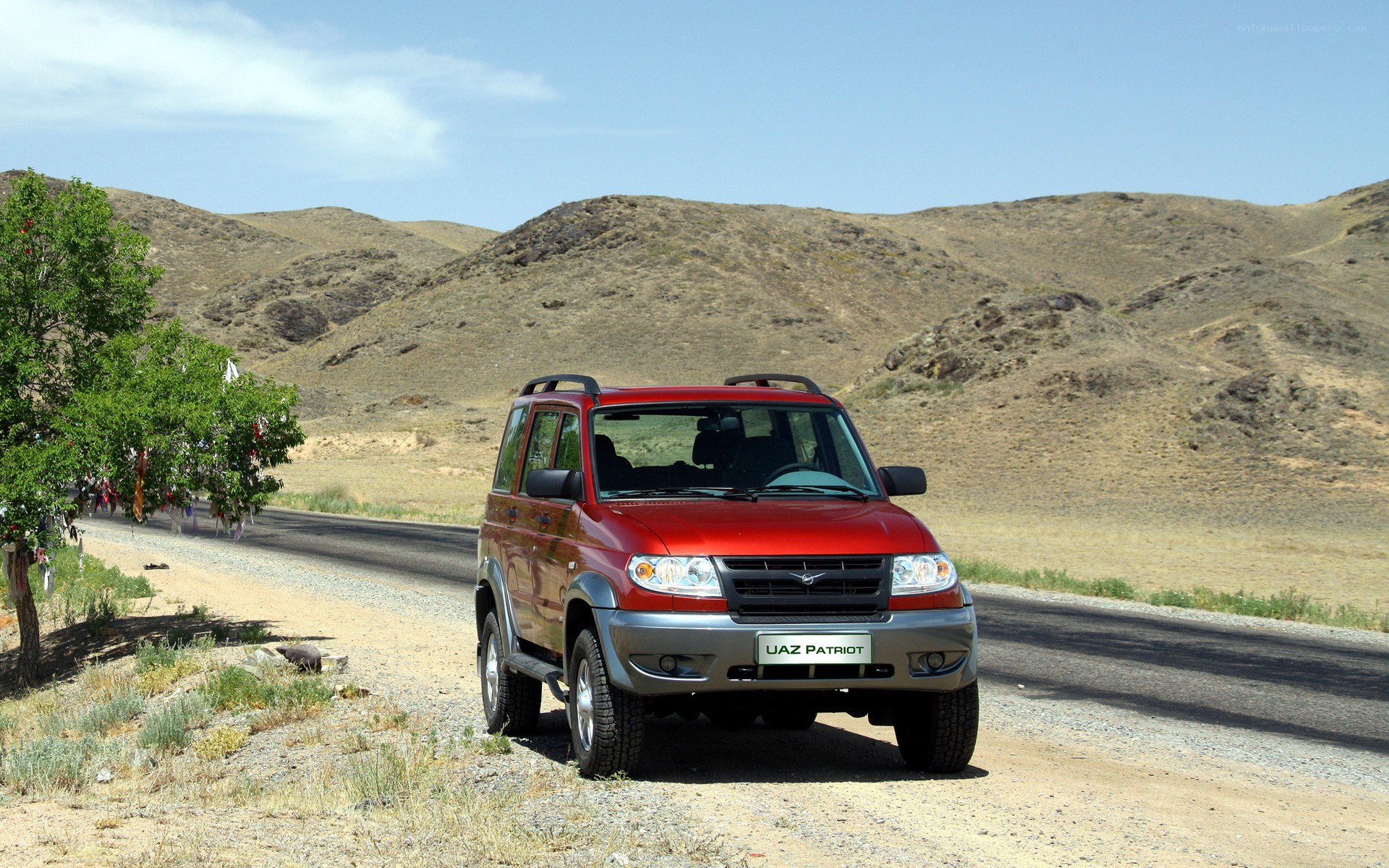 Red SUV on a desert road