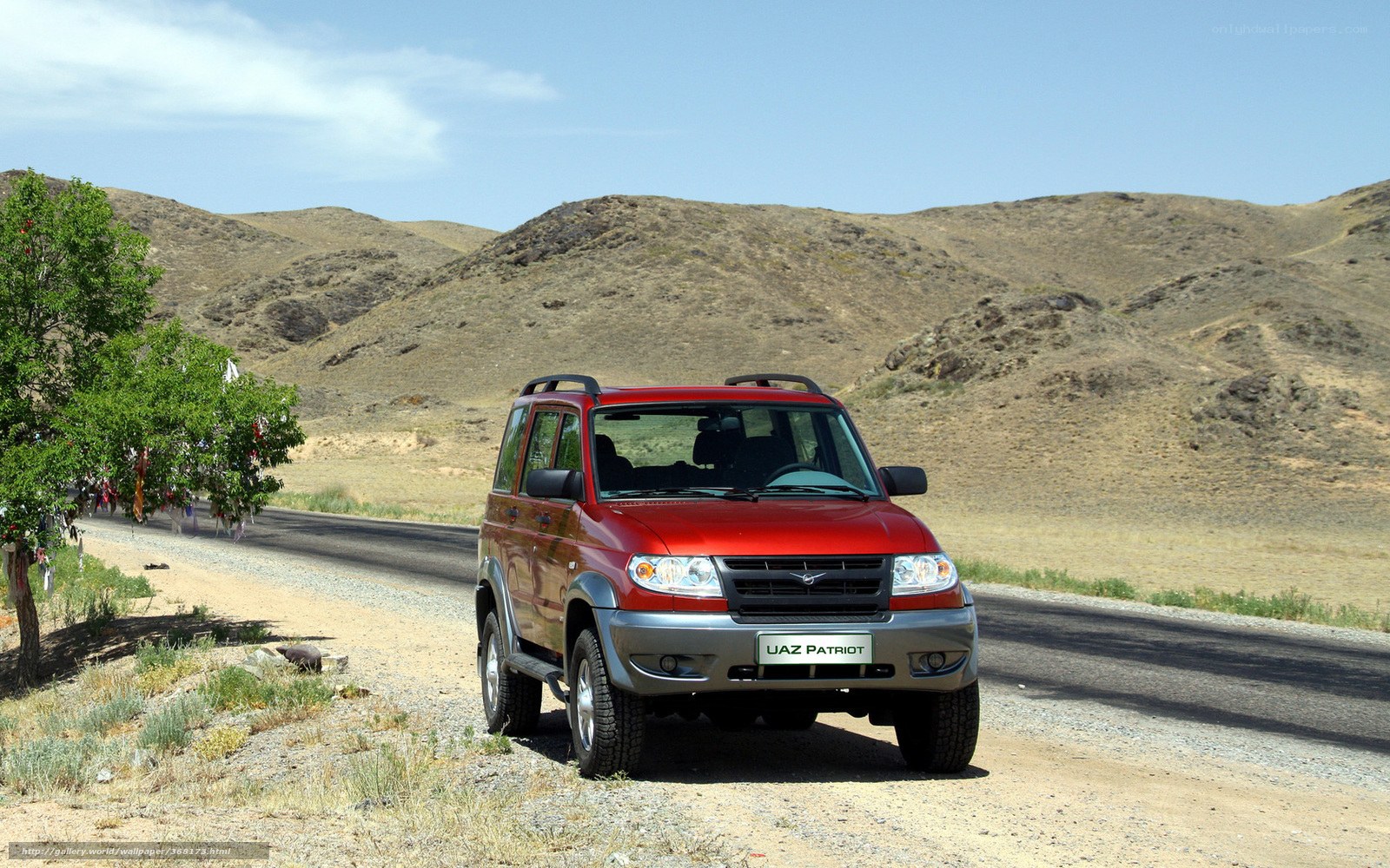 Red SUV on a desert road