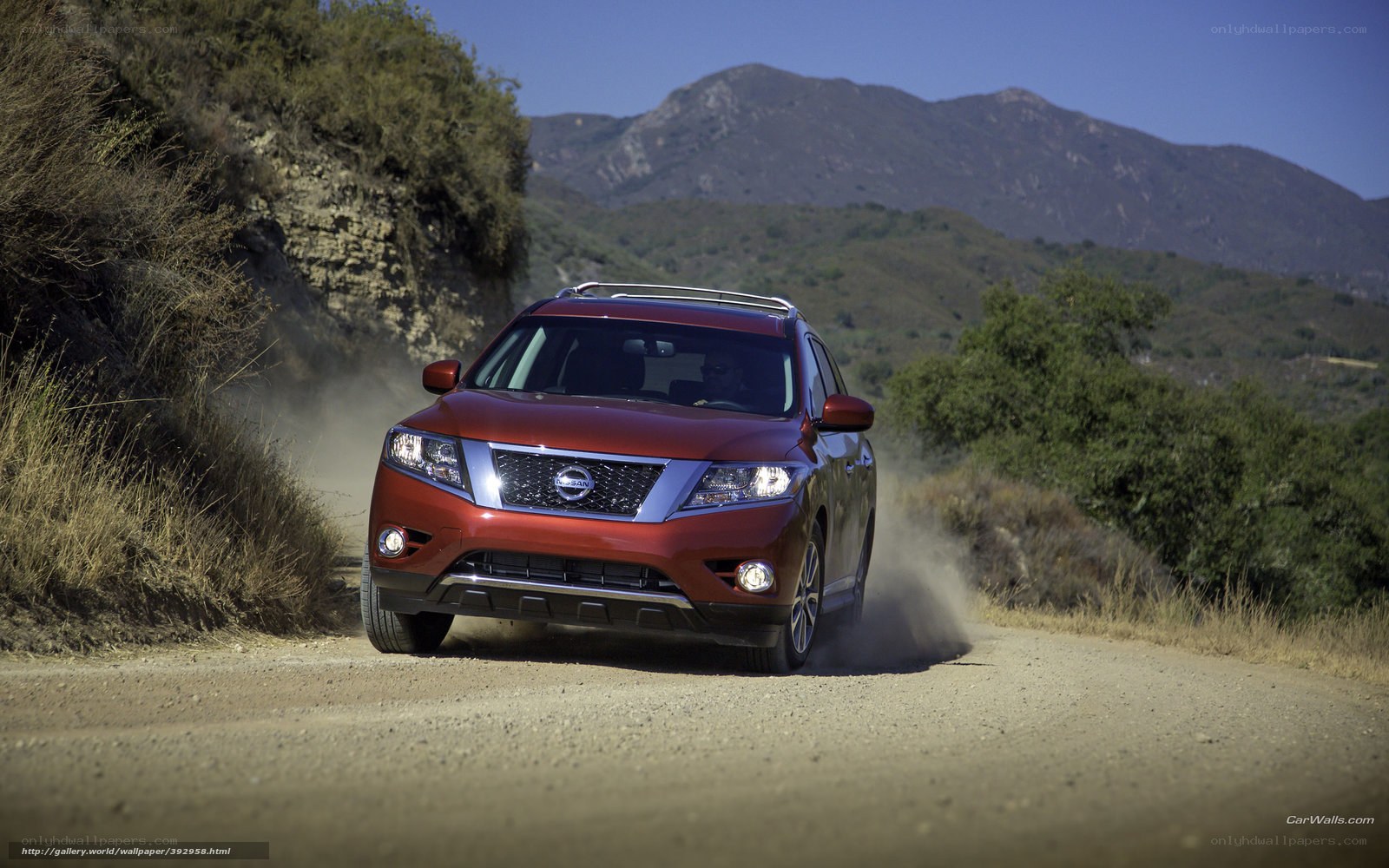 Red SUV on a dirt road