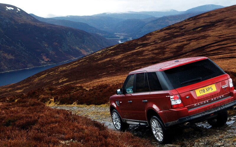 Red SUV on a mountain trail
