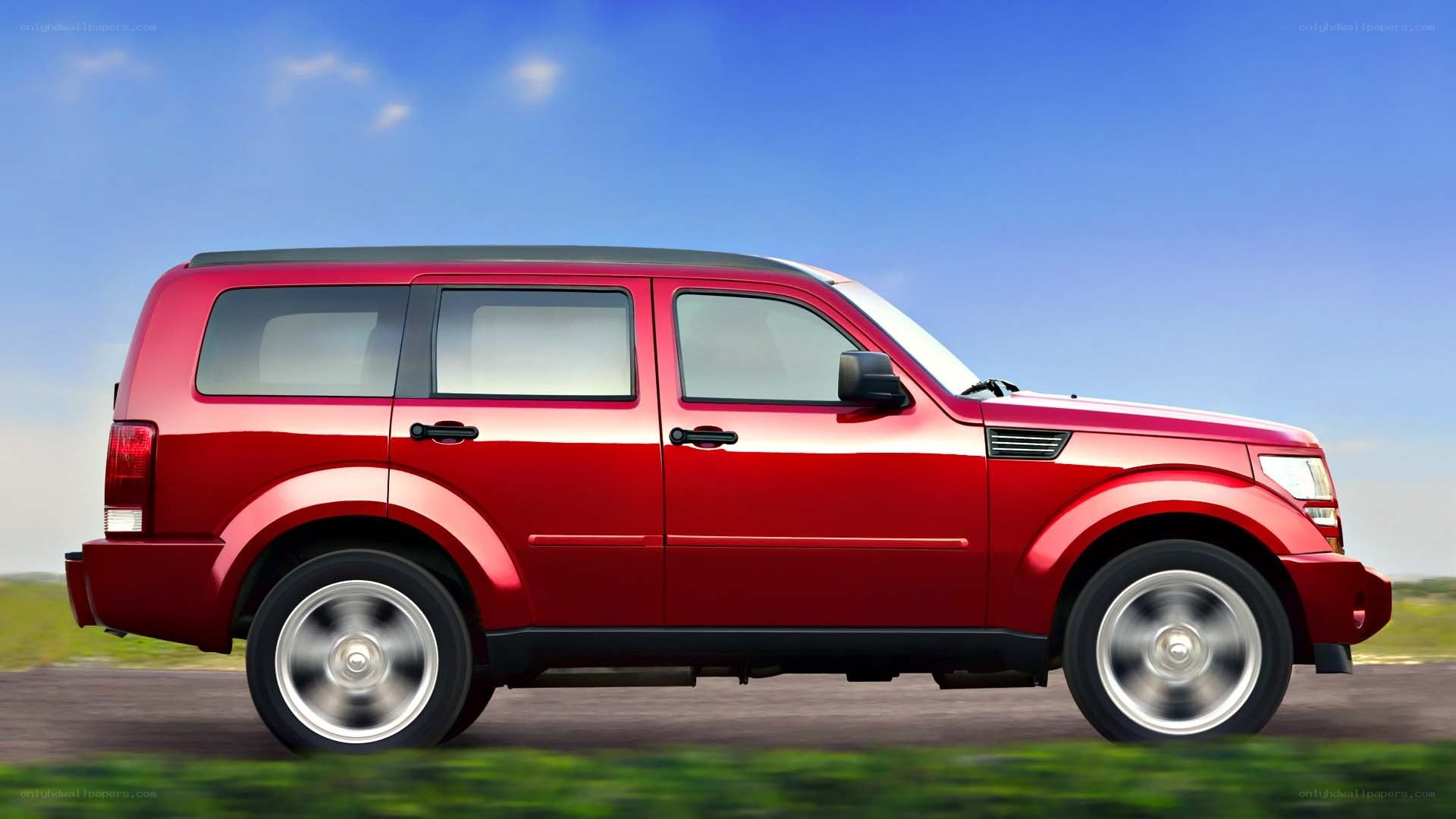 red suv on a road