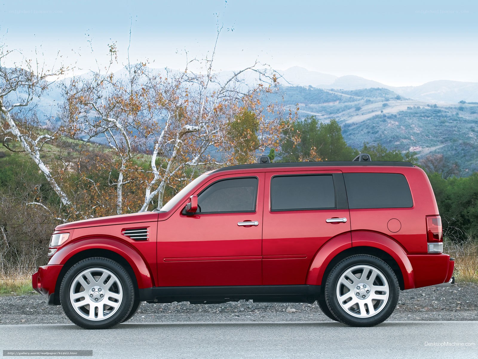 Red SUV on a scenic road