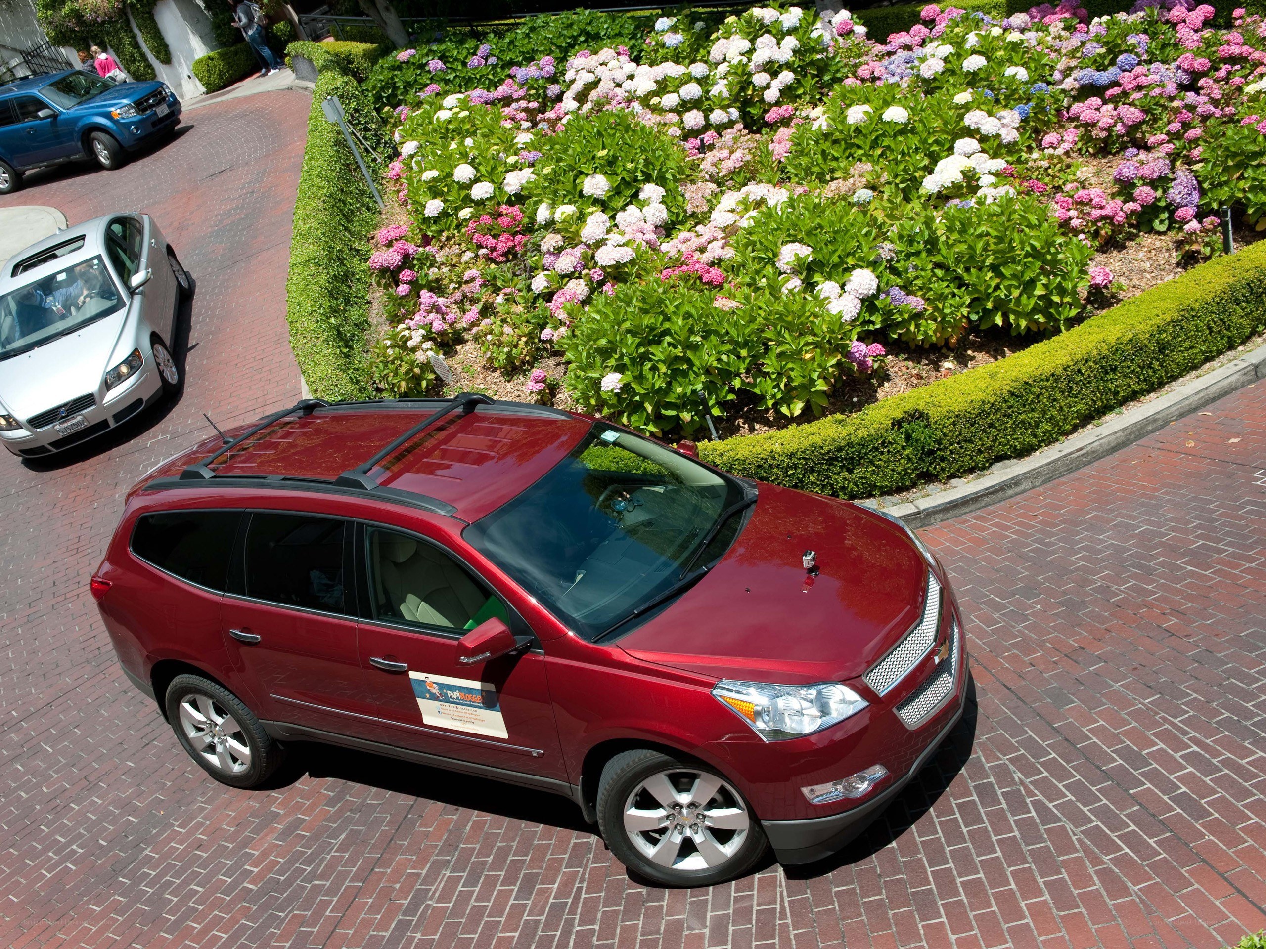 Red SUV on brick road