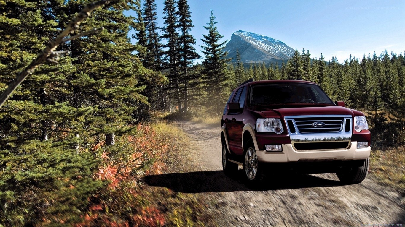 Red SUV on forest trail
