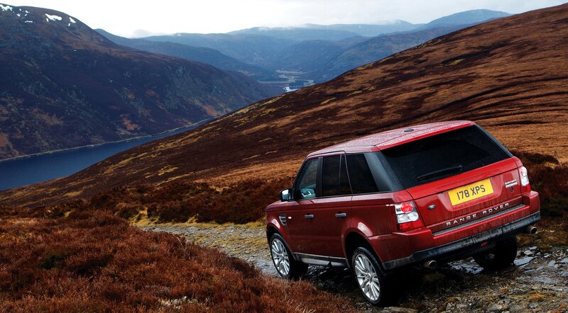 Red SUV on Hillside — Dramatic