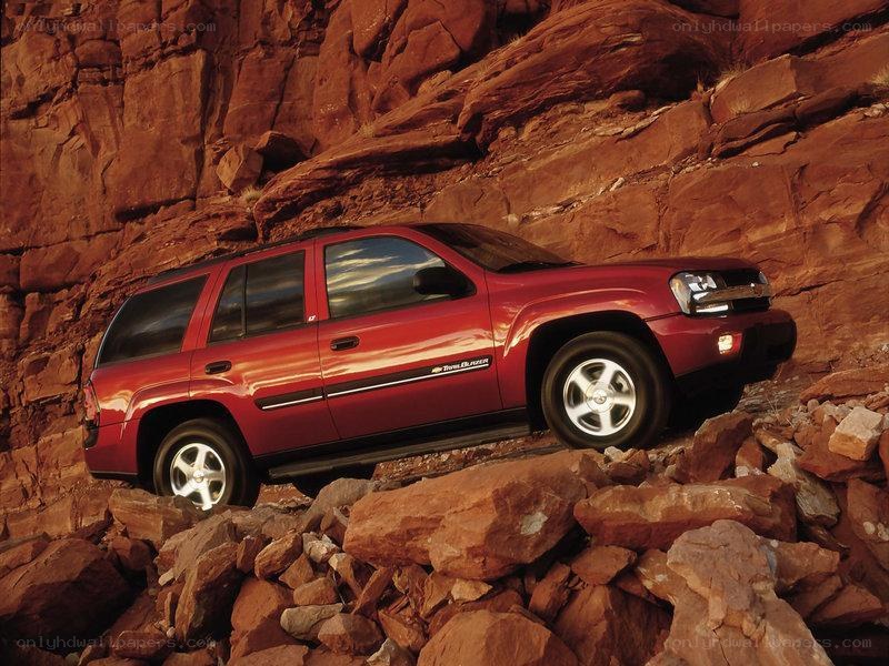 Red SUV on rocky terrain