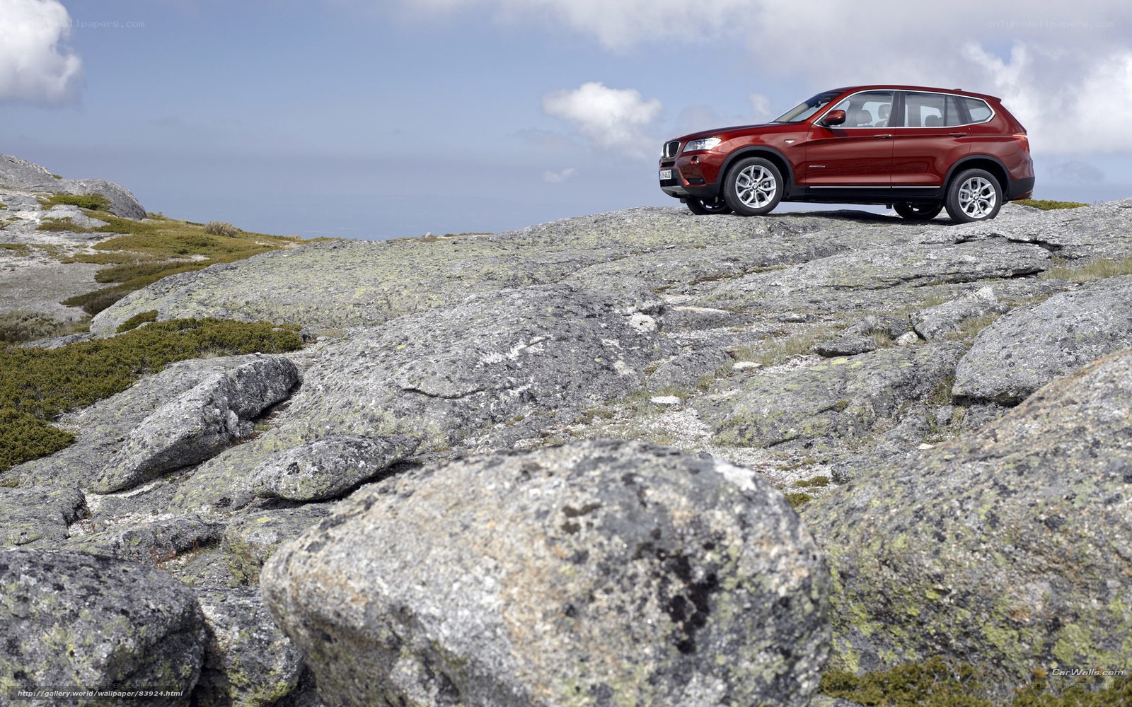 Red SUV on rocky terrain