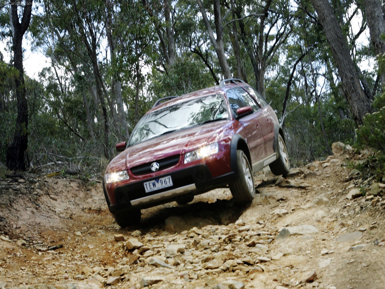 Red SUV on rocky trail
