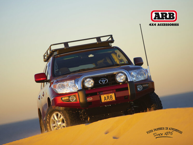 Red SUV on sand dune