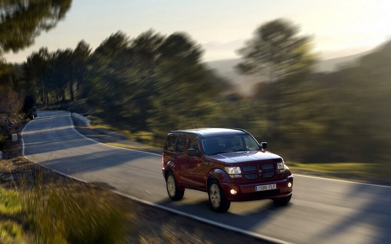 Red SUV on winding road