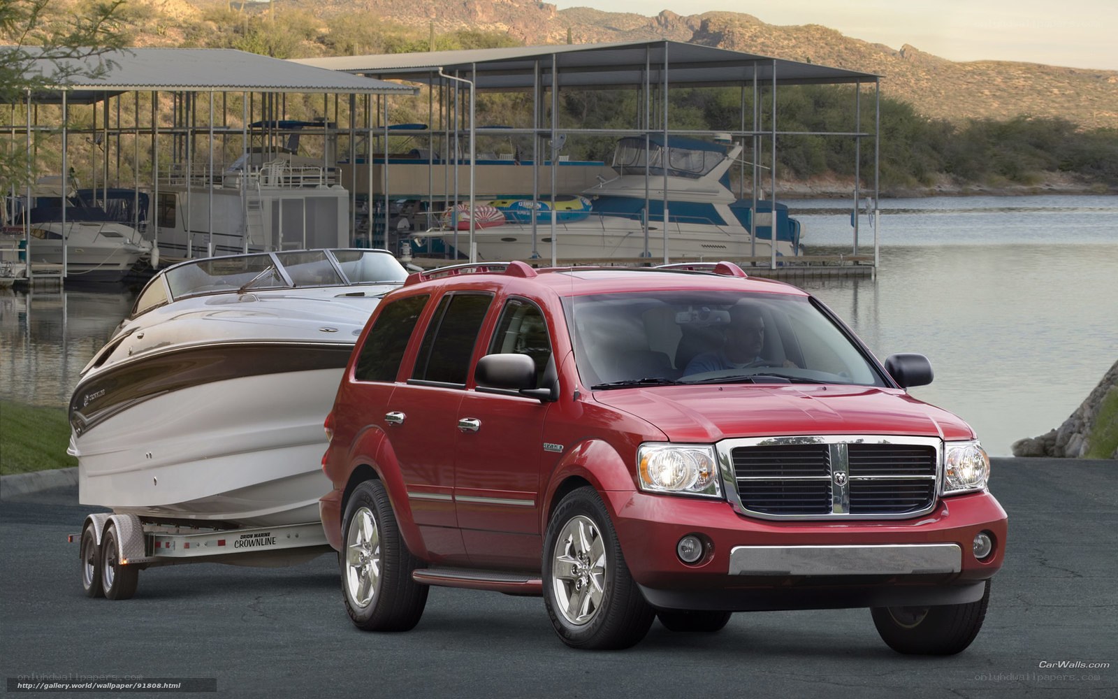 Red SUV towing a boat