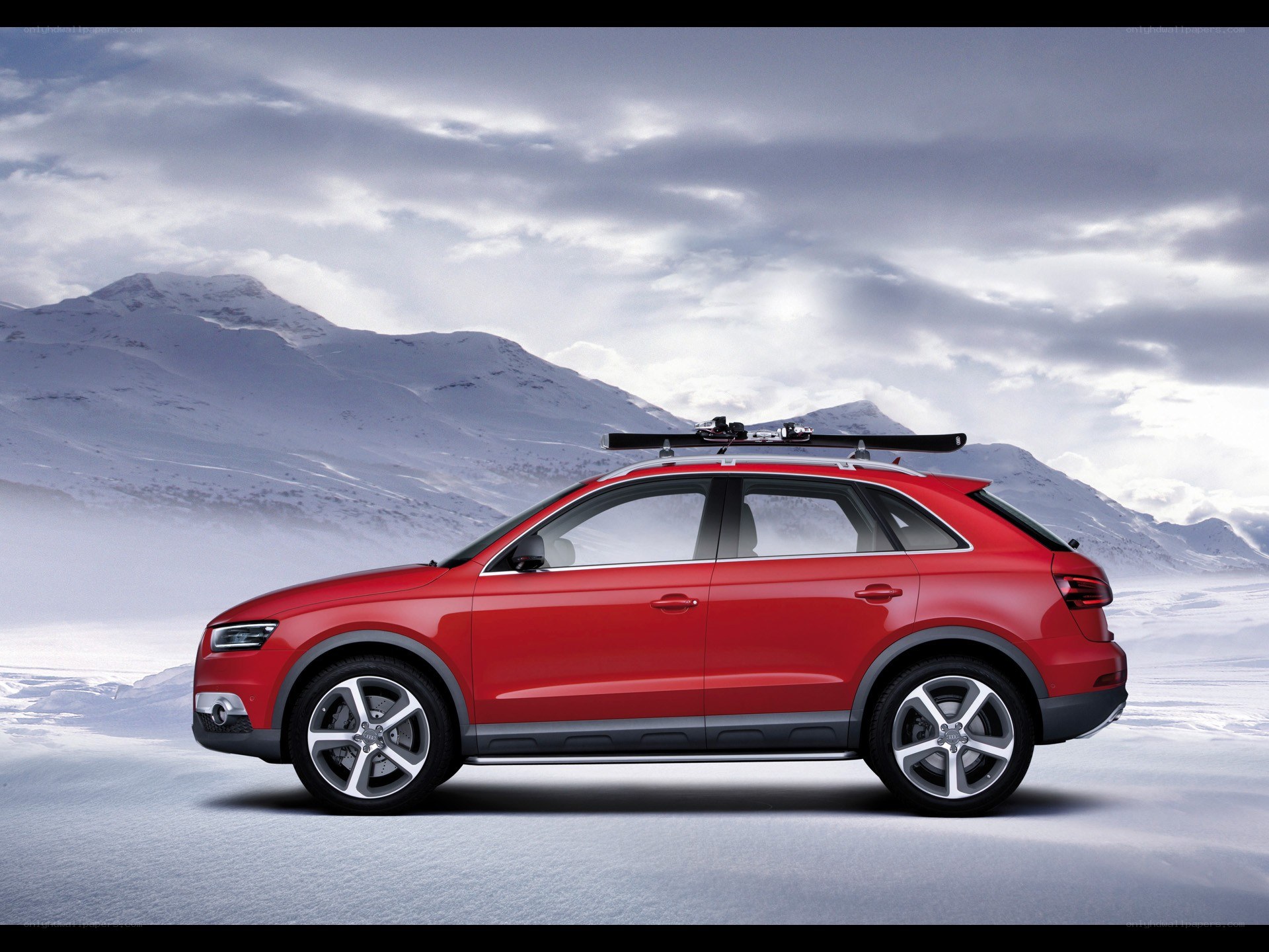 Red SUV with skis in snow