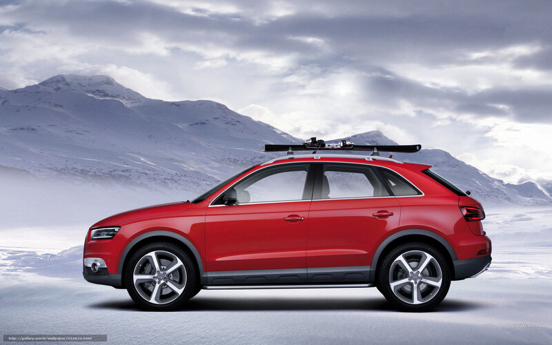 Red SUV with skis in snowy mountains