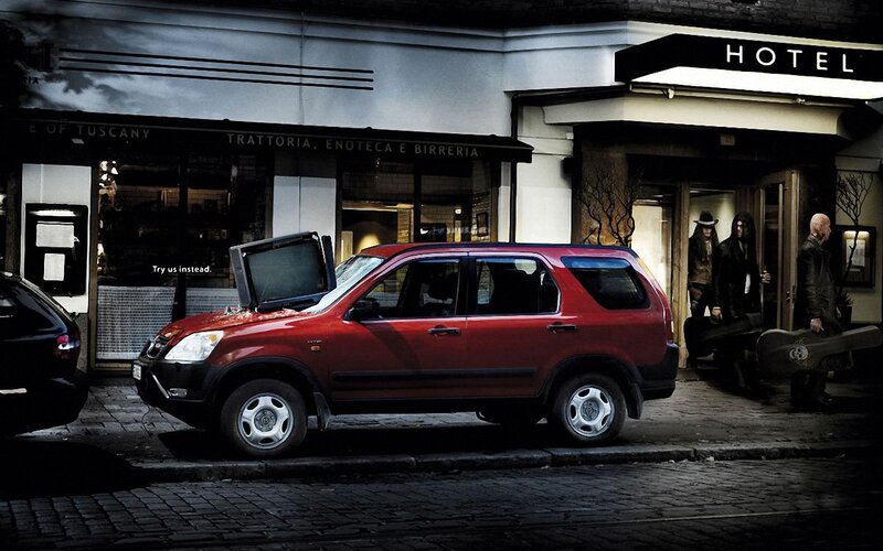 Red SUV with TV on hood