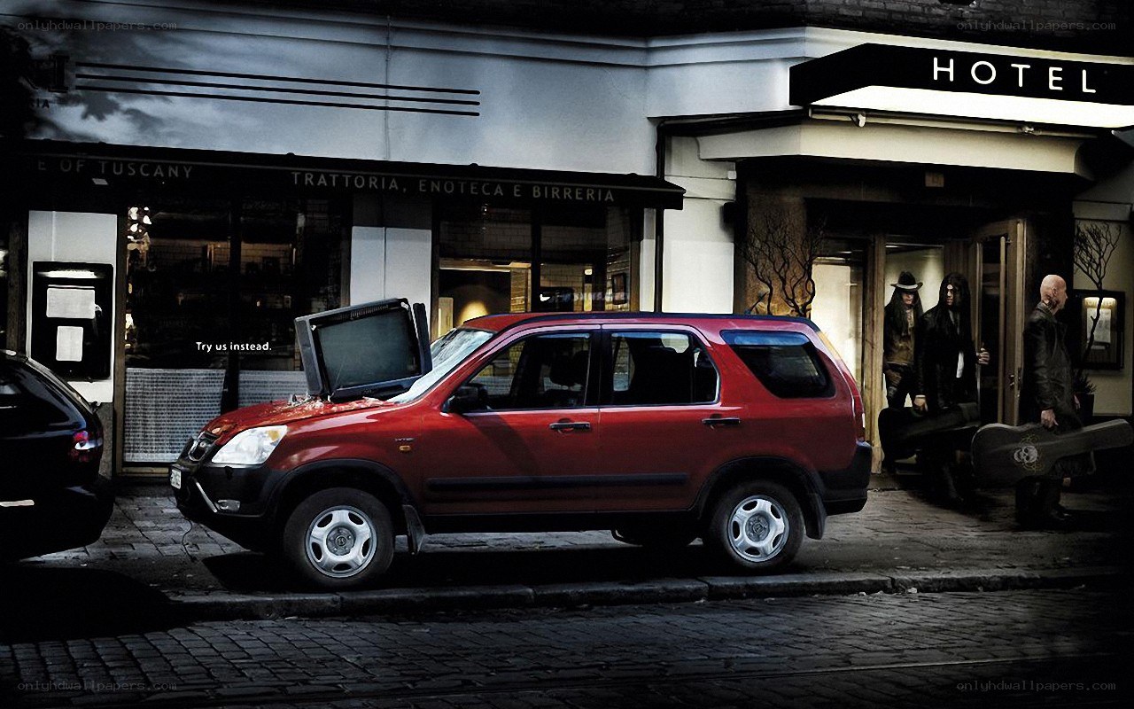 Red SUV with TV on hood