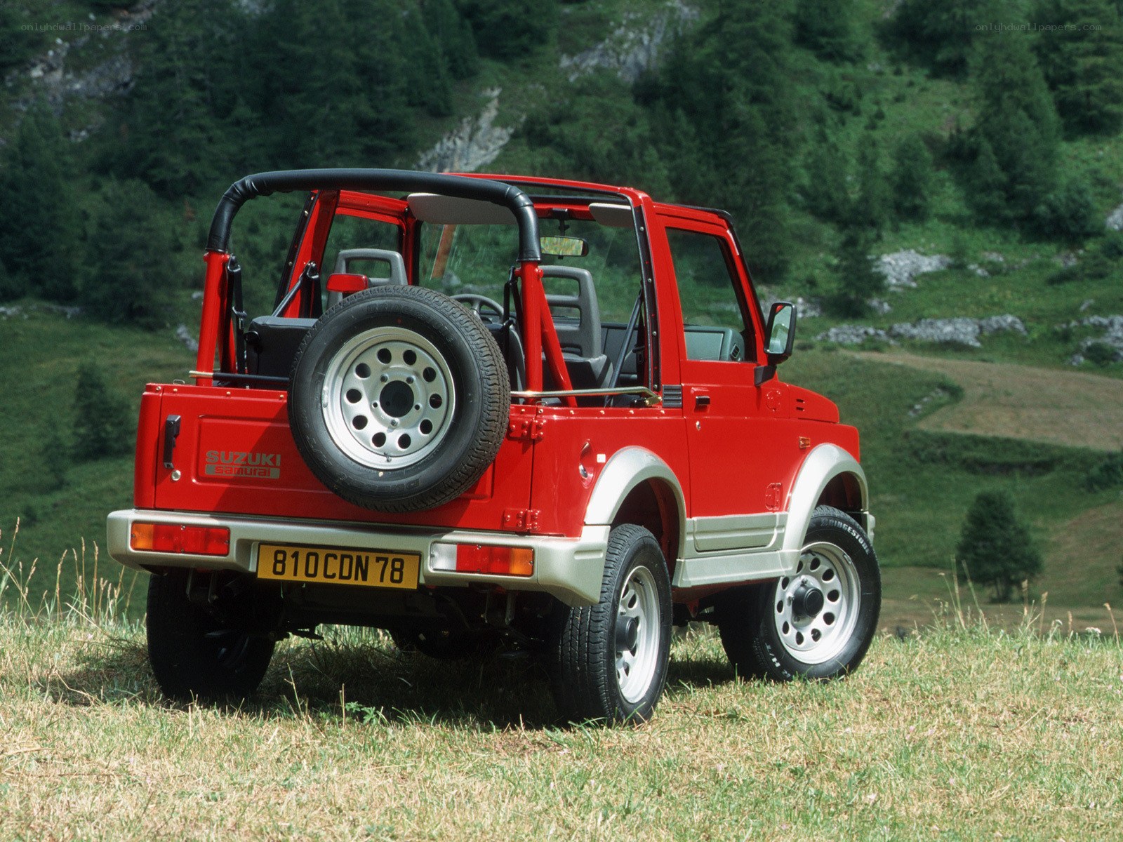 Red Suzuki Samurai in a field