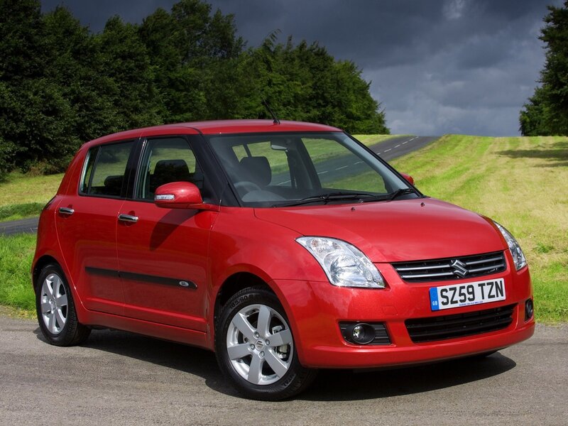 Red Suzuki Swift on a country road