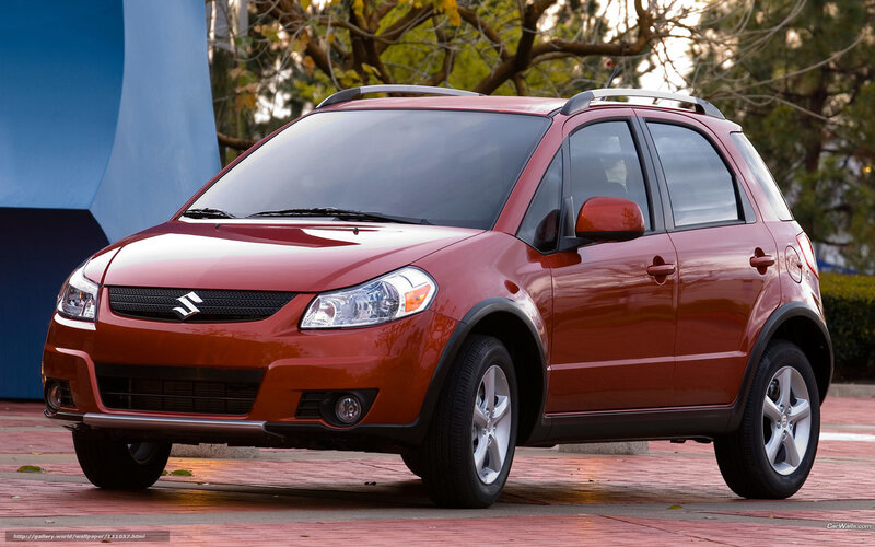 Red Suzuki SX4 parked outdoors