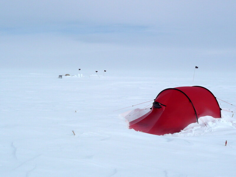 Red tent in snowy landscape
