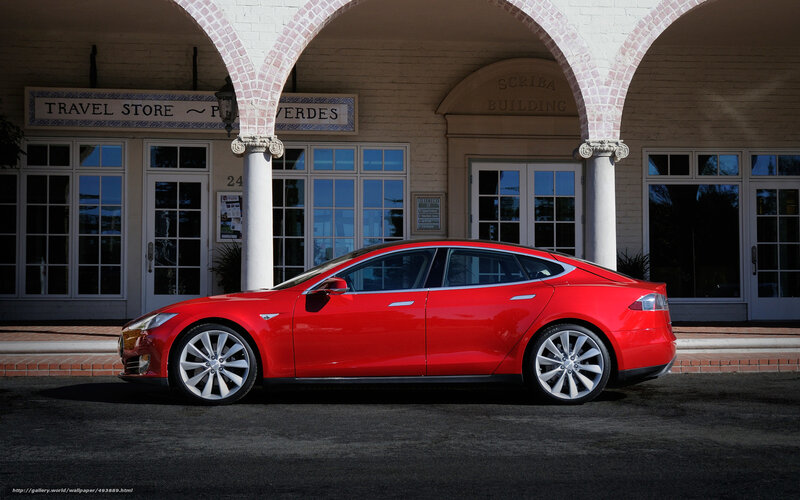 Red Tesla Model S in front of building