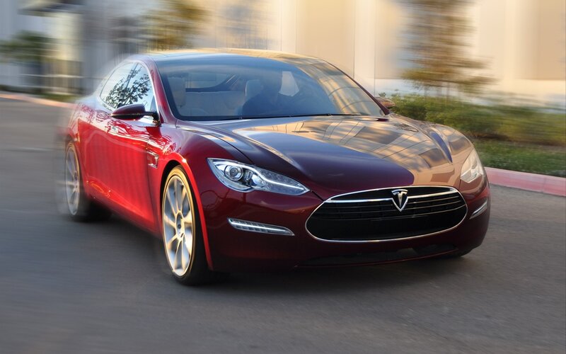 Red Tesla Model S in motion