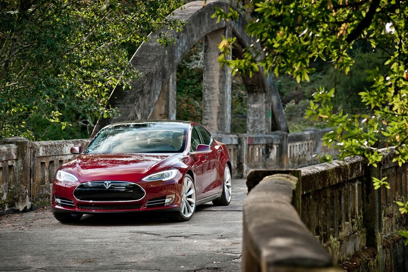 Red Tesla on a stone bridge