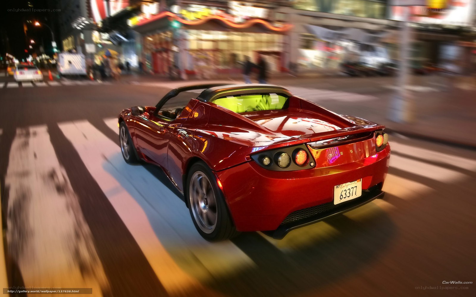 Red Tesla Roadster at night