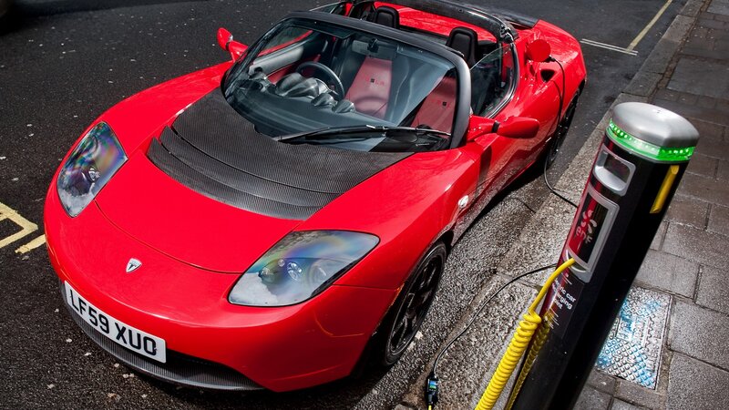 Red Tesla Roadster charging
