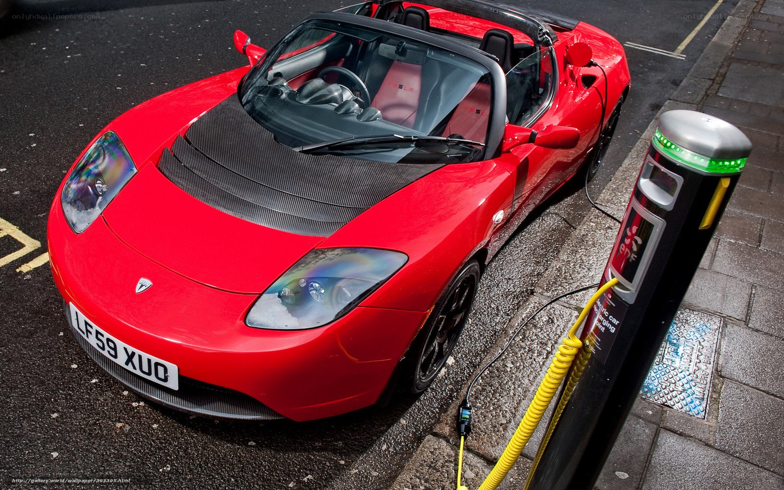 Red Tesla Roadster charging