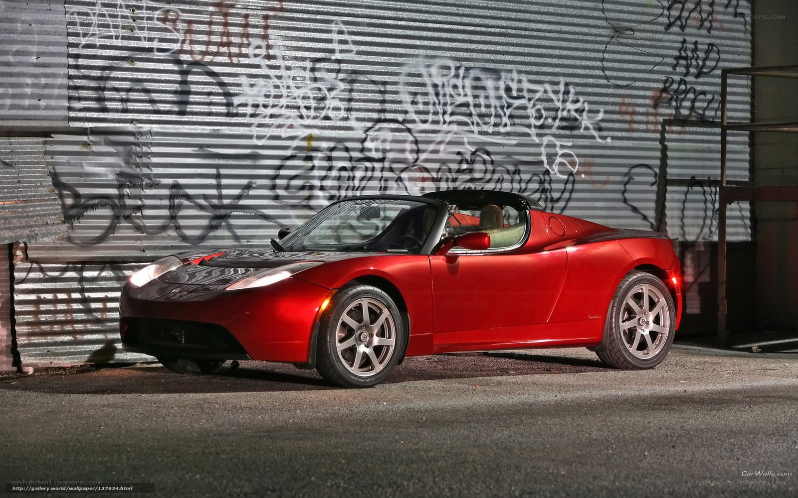 Red Tesla Roadster in alley
