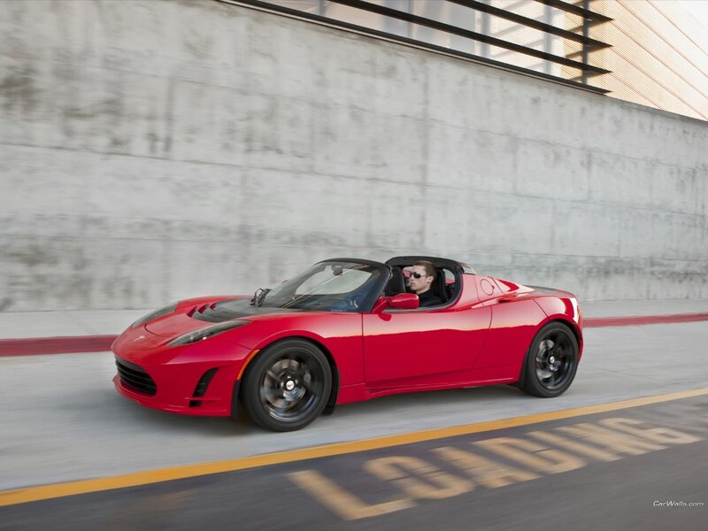 Red Tesla Roadster in motion
