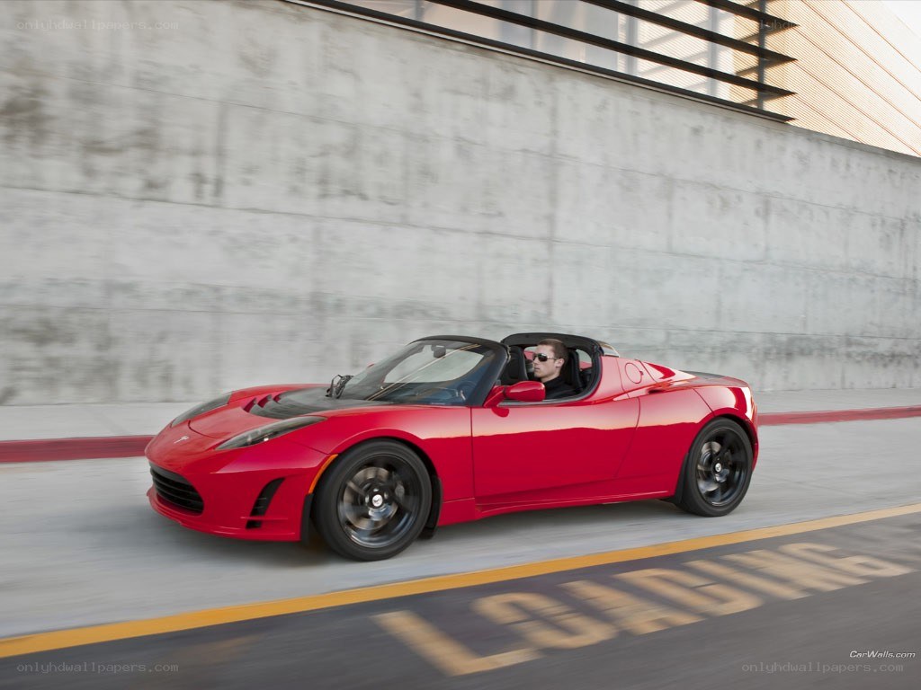 Red Tesla Roadster in motion